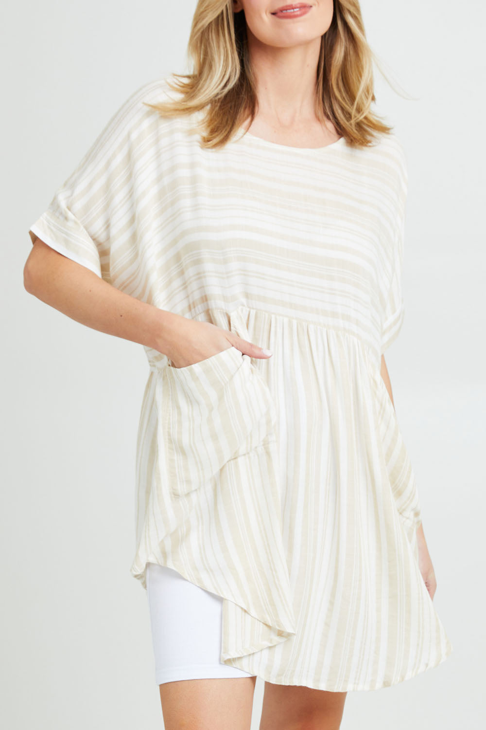 Model Grace wearing the Beachy Top in colour Beige, from the front, cropped image