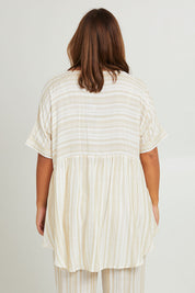 Model Monique wearing the Beachy Top in colour Beige, from the back
