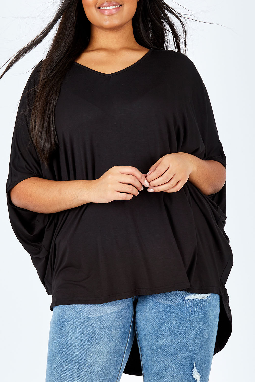 Model Shanaya wearing size OneSize of the Long Sleeve Hi Low Top in colour Black (Black), from the front, cropped image