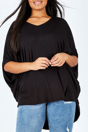 Model Shanaya wearing size OneSize of the Long Sleeve Hi Low Top in colour Black (Black), from the front, cropped image