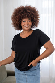 A model wearing the Destiny Top in colour Black (Black), from the front, cropped image