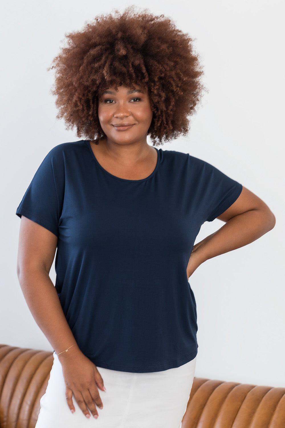 A model wearing the Destiny Top in colour Navy (Blue), from the front, cropped image