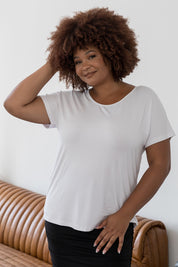 A model wearing the Destiny Top in colour White (White), from the front, cropped image