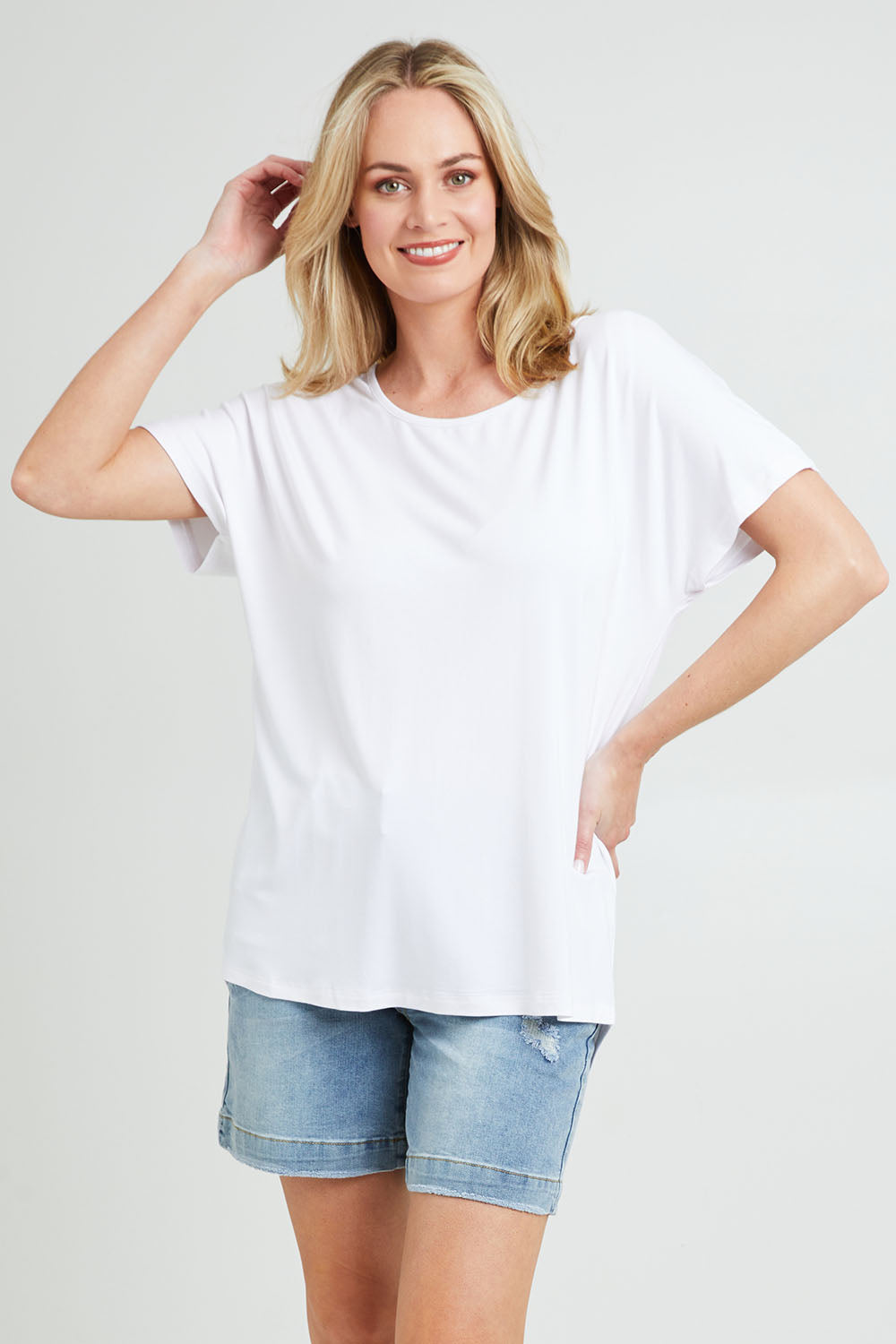 Model Grace wearing the Destiny Top in colour White (White), from the front, cropped image