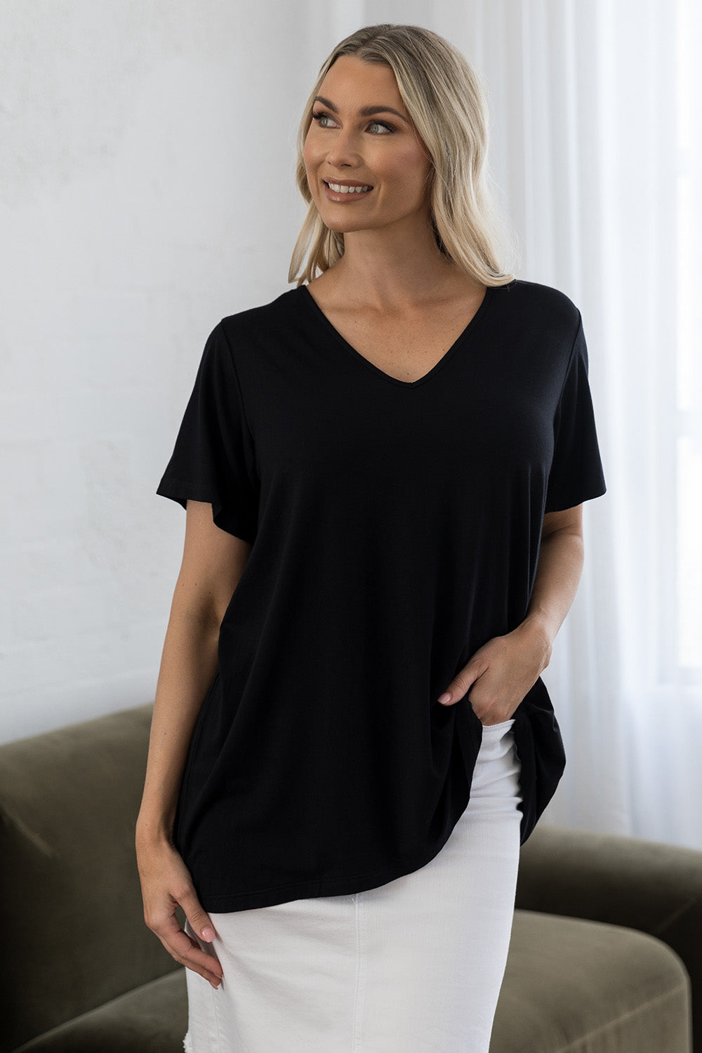 A model wearing the Tin colourShirt S/S Top - Black (Black), from the front, cropped image