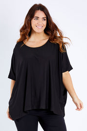 Model Laura wearing size OneSize of the Nice Top in colour Black (Black), from the front, cropped image