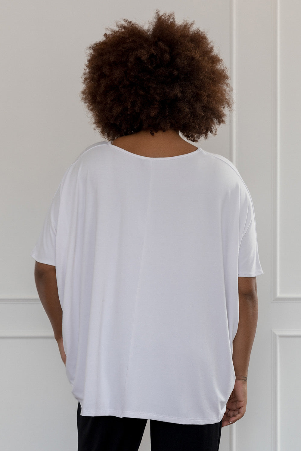 A model wearing the Nice Top in colour White (White), from the back