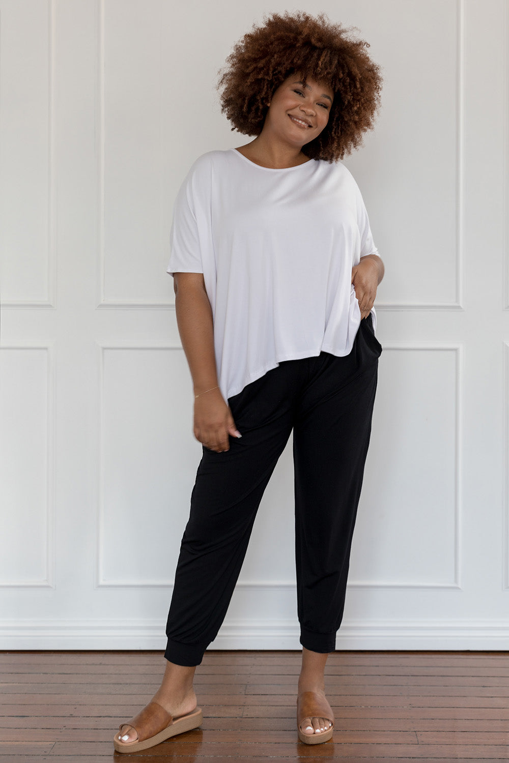 A model wearing the Nice Top in colour White (White), from the front, showing the whole outfit