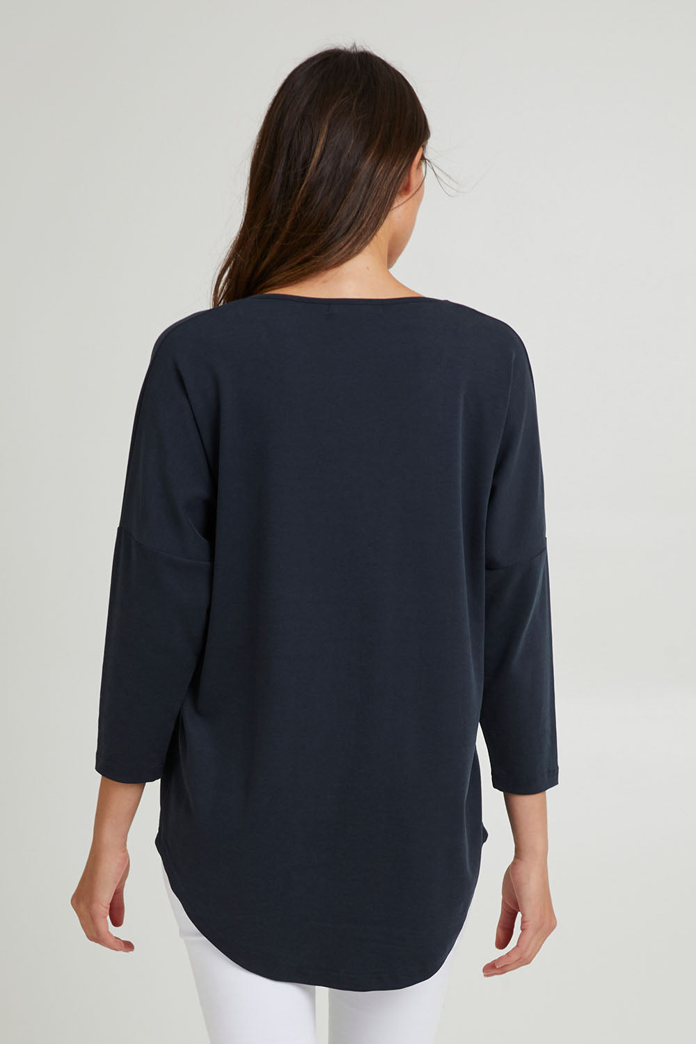 Model Madeline wearing the L/S Destiny Lounge Top in colour Spaceblue (Blue), from the back