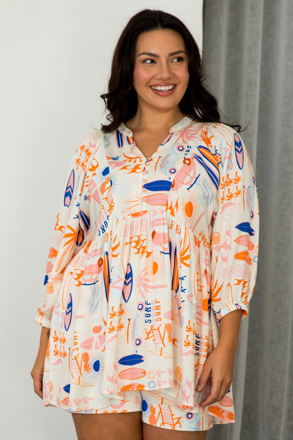 A model wearing the Charlie Top in colour Surfsup, from the front, cropped image