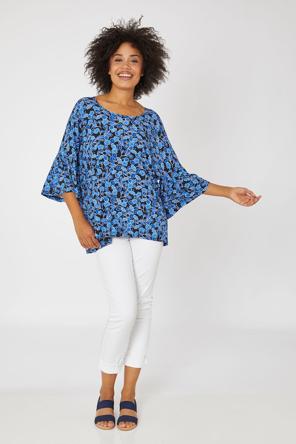 Model Olivia wearing the Frill Top in colour Bluegum (Blue), from the front, showing the whole outfit