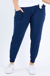 Model Laura wearing size M of the Everyday Pant in colour Navy (Blue), from the front, cropped image