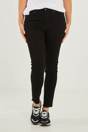 Model Georgia wearing size S of the Frayed Slim Fit Jean in colour Black (Black), from the front, cropped image