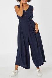 Model Olivia wearing the Button Down Jumpsuit in colour Navy (Blue), from the front, cropped image