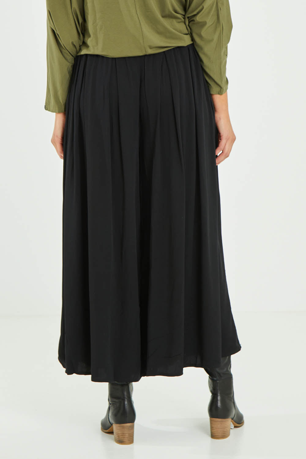 Model Madeline wearing size S of the Ultimate Pant in colour Black (Black), from the back