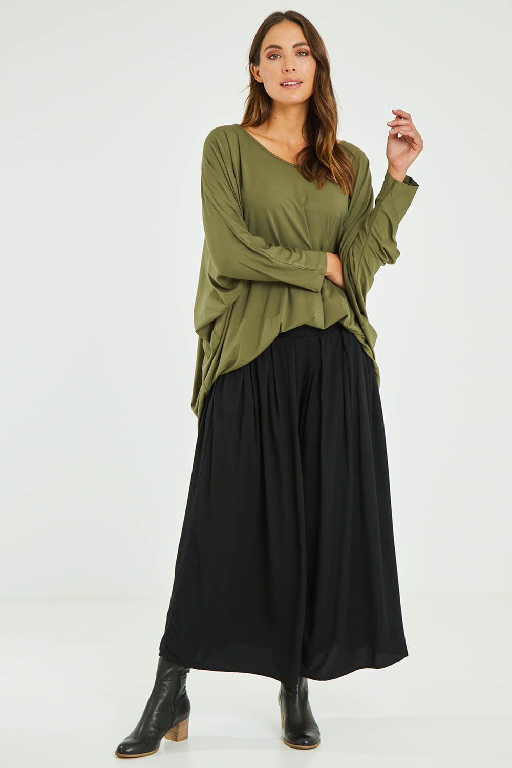 Model Madeline wearing size S of the Ultimate Pant in colour Black (Black), from the front, showing the whole outfit