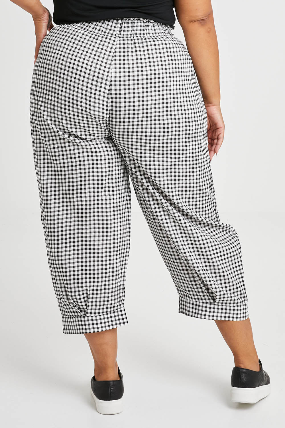 Model Alexis wearing size XL of the Archer Pant in colour Nightcheck (Blue), from the back