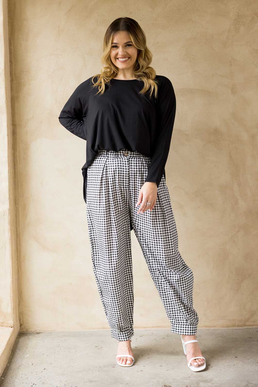 A model wearing the Archer Pant in colour Nightcheck (Blue), from the front, showing the whole outfit