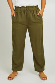 Model Monique wearing size L of the Olivia Pant in colour Greenenvy (Green), from the front, cropped image