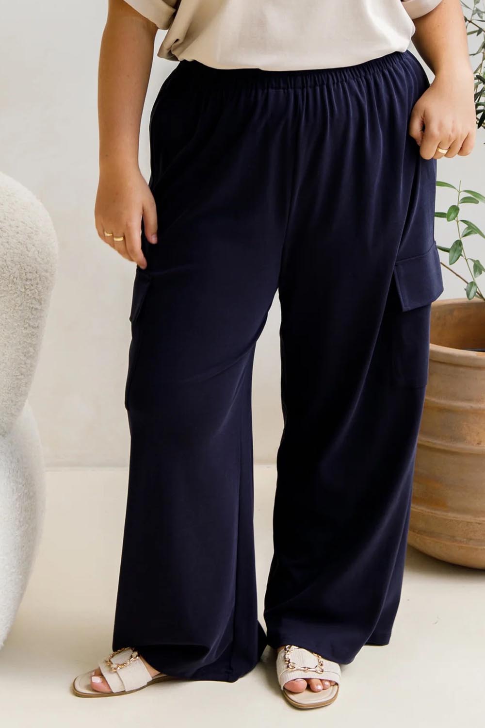 A model wearing the Eden Cotton Blend Pants in colour Midnight (Blue), from the front, cropped image