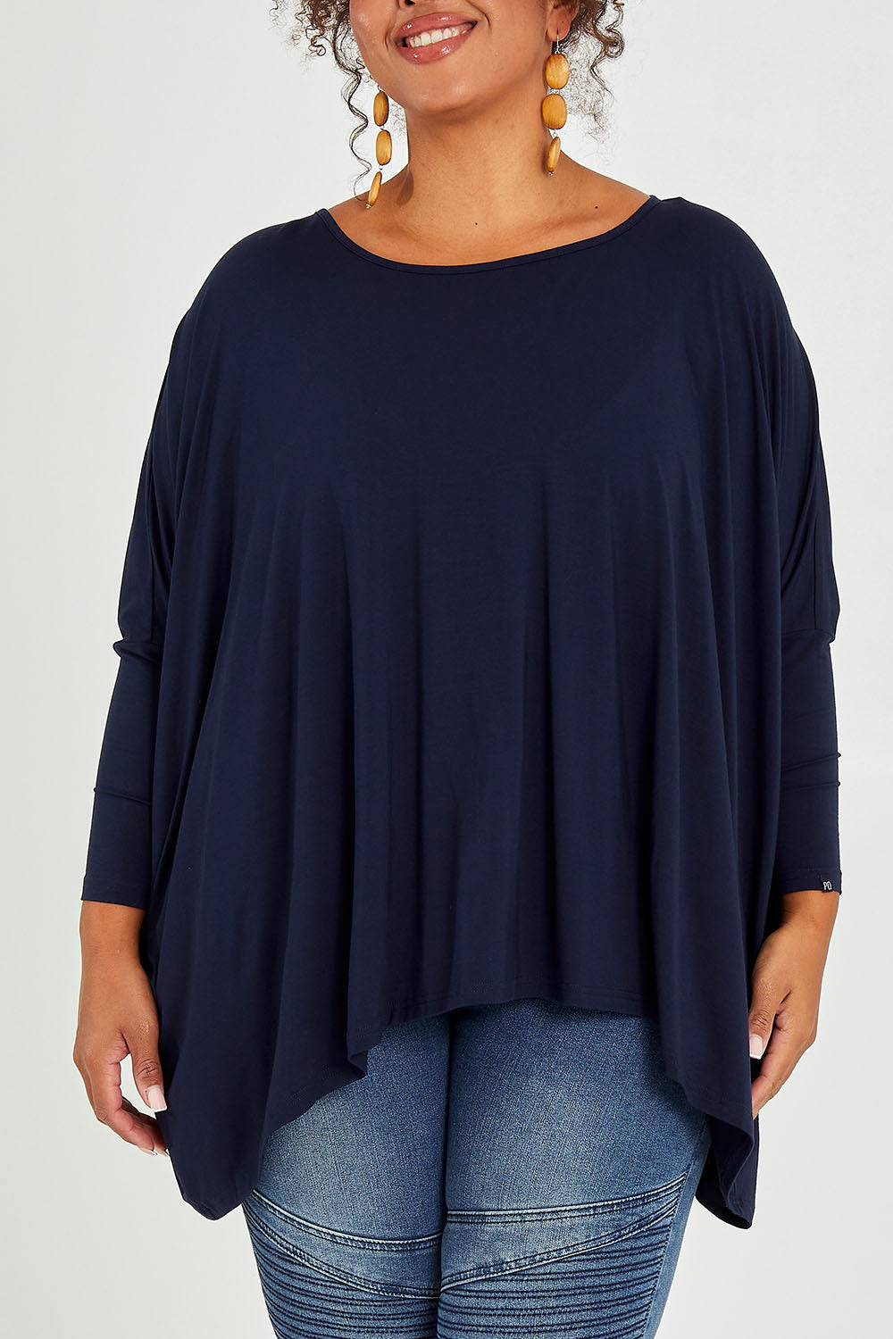 Model Alexis wearing size OneSize of the Long Sleeve Essential Top in colour Navy (Blue), from the front, cropped image
