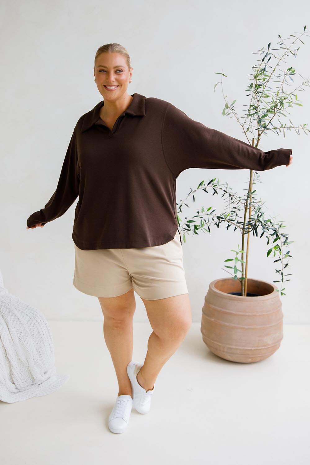 A model wearing the Gigi Lounge Sweater in colour Chocolate, from the front, showing the whole outfit