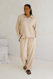 A model wearing the Gigi Lounge Sweater in colour Portobeige, from the front, showing the whole outfit
