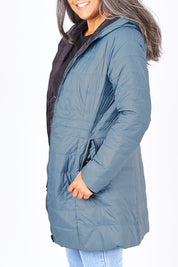 Model Nadine wearing size 10 of the Reversible Down Jacket in colour CharBlack (Grey), from the front, cropped image
