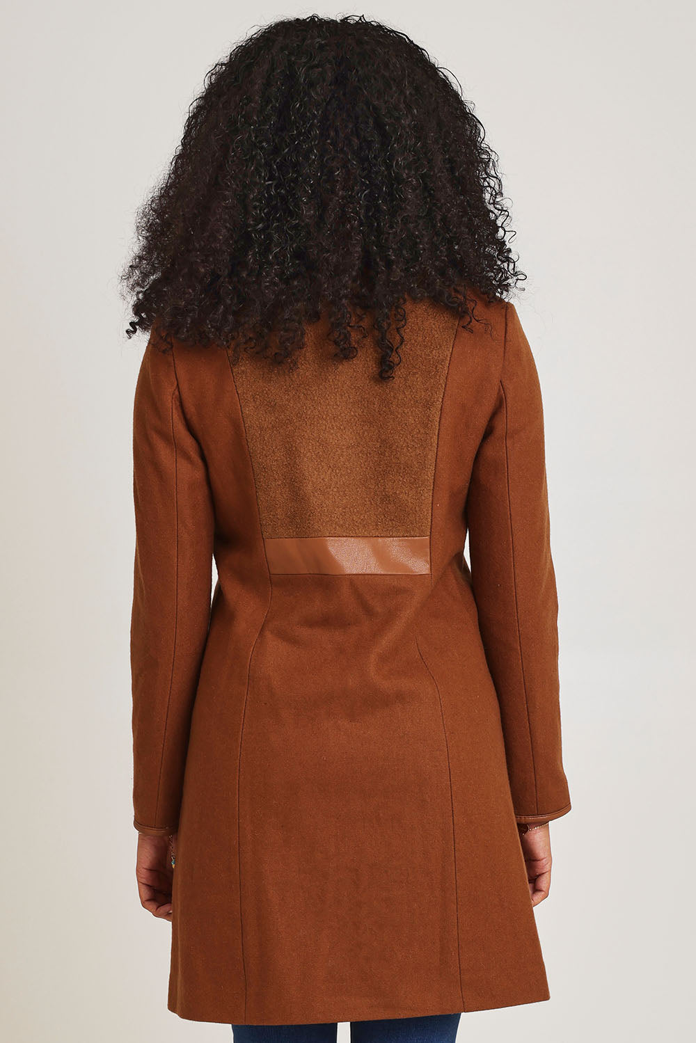 Model Ziara wearing size 10 of the Multi Fabric Jacket in colour Latte, from the back