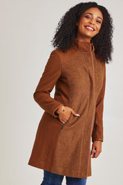 Model Ziara wearing size 10 of the Multi Fabric Jacket in colour Latte, from the front, cropped image