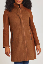 Model Ziara wearing size 10 of the Multi Fabric Jacket in colour Latte, from the front, cropped image