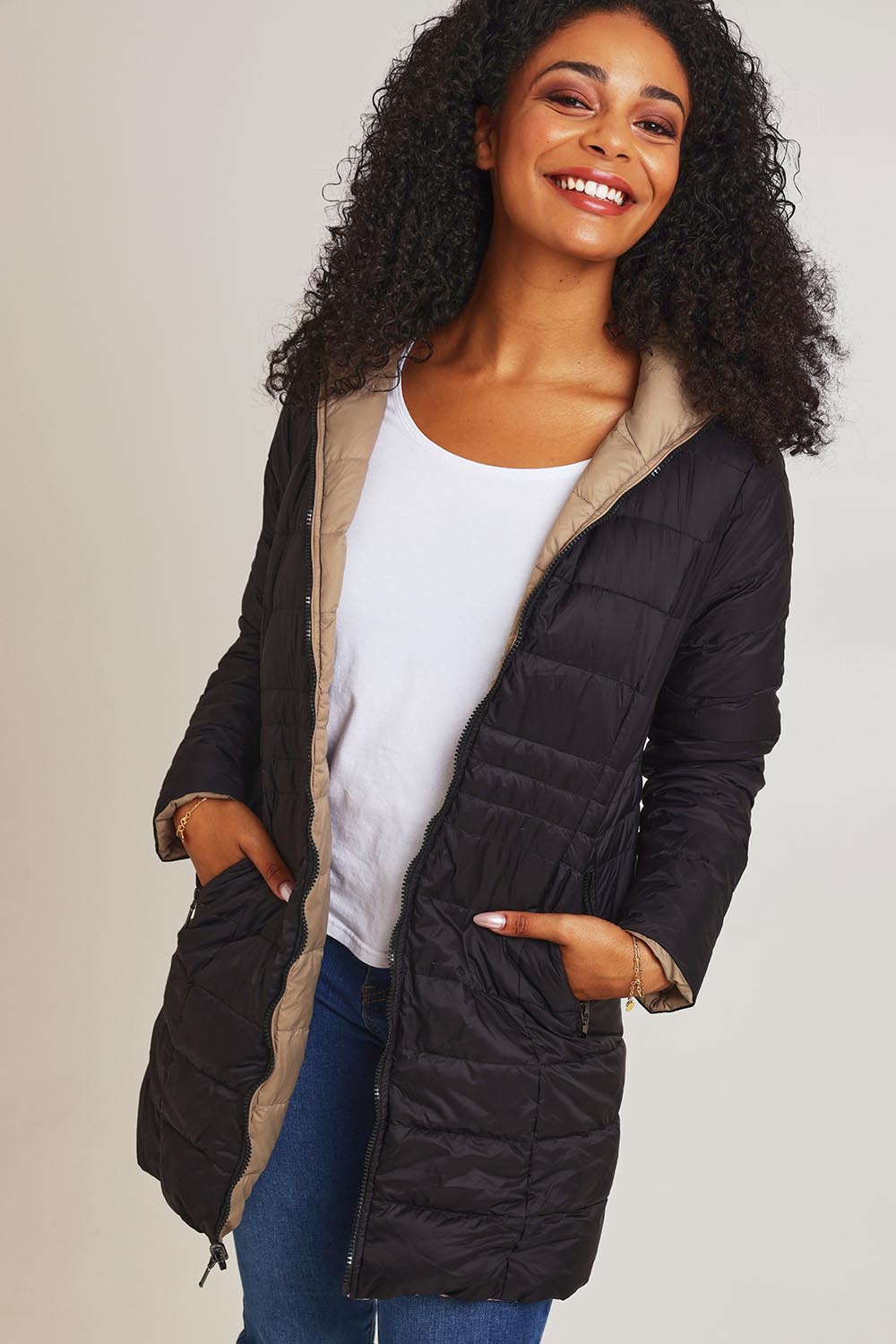 Model Ziara wearing size 10 of the 3/4 Reversible Down Jacket in colour Minkblk (Black), from the front, cropped image
