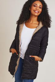 Model Ziara wearing size 10 of the 3/4 Reversible Down Jacket in colour Minkblk (Black), from the front, cropped image