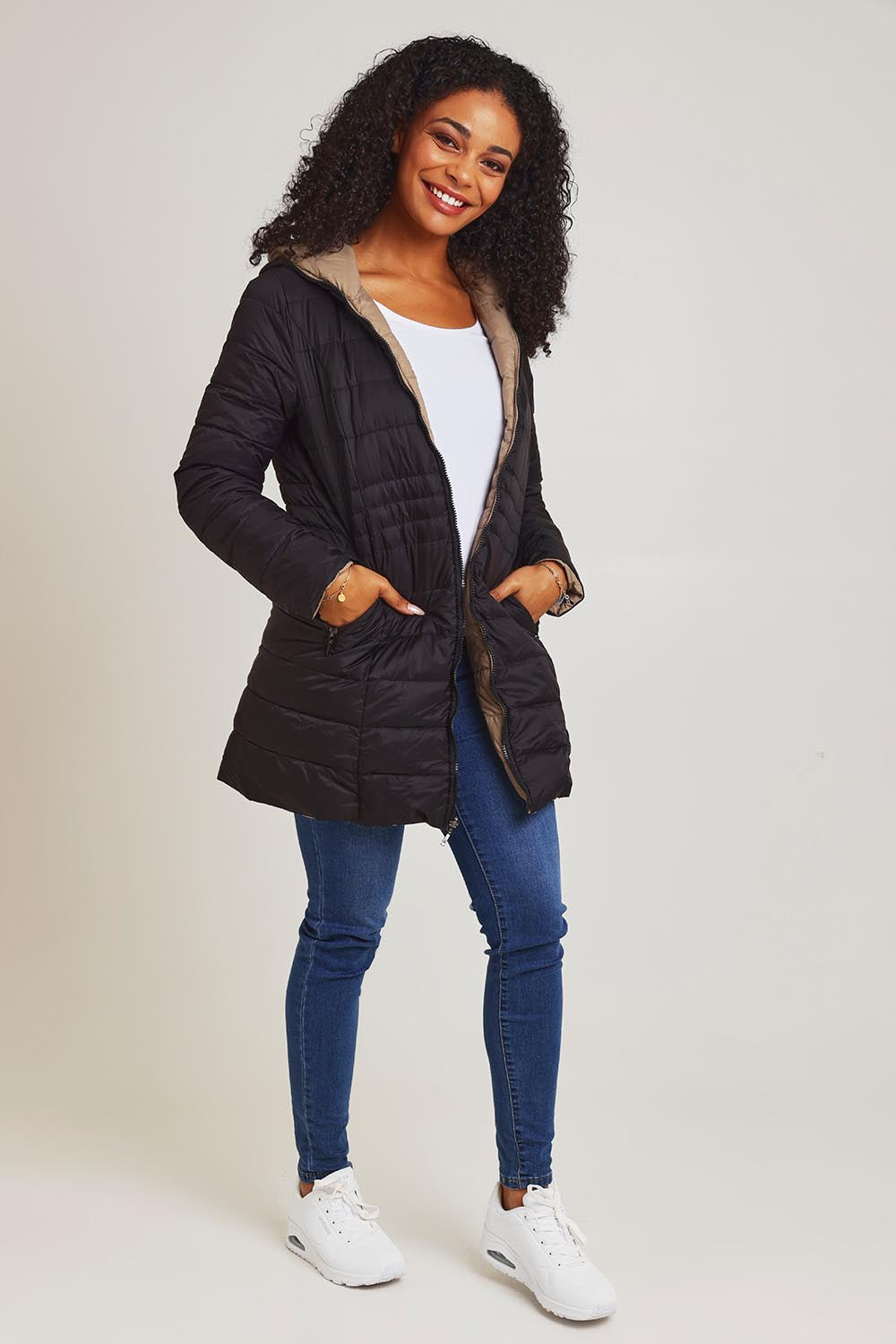 Model Ziara wearing size 10 of the 3/4 Reversible Down Jacket in colour Minkblk (Black), from the front, showing the whole outfit