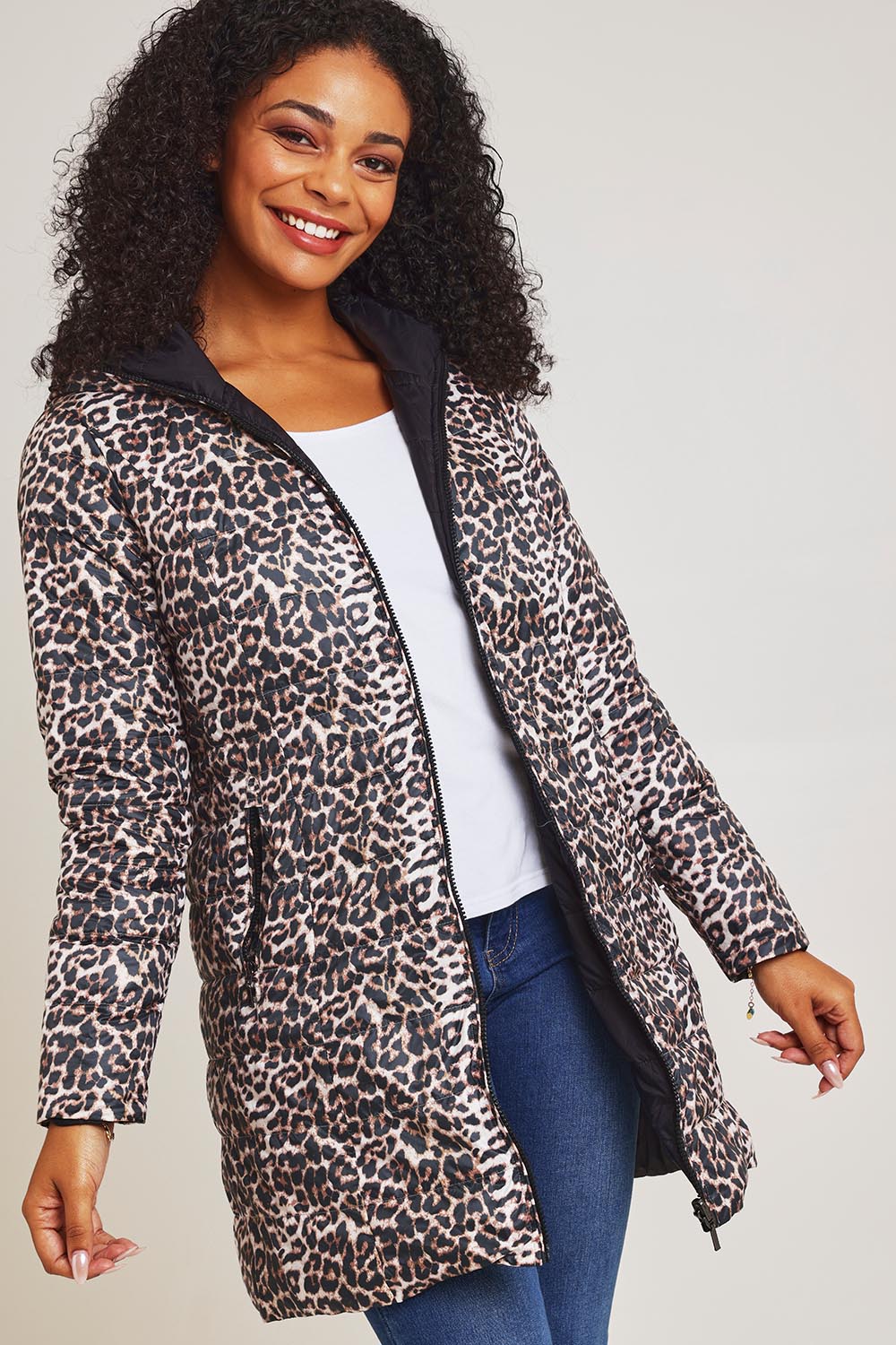 Model Ziara wearing size 10 of the 3/4 Reversible Down Jacket in colour Safari (Black), from the front, cropped image