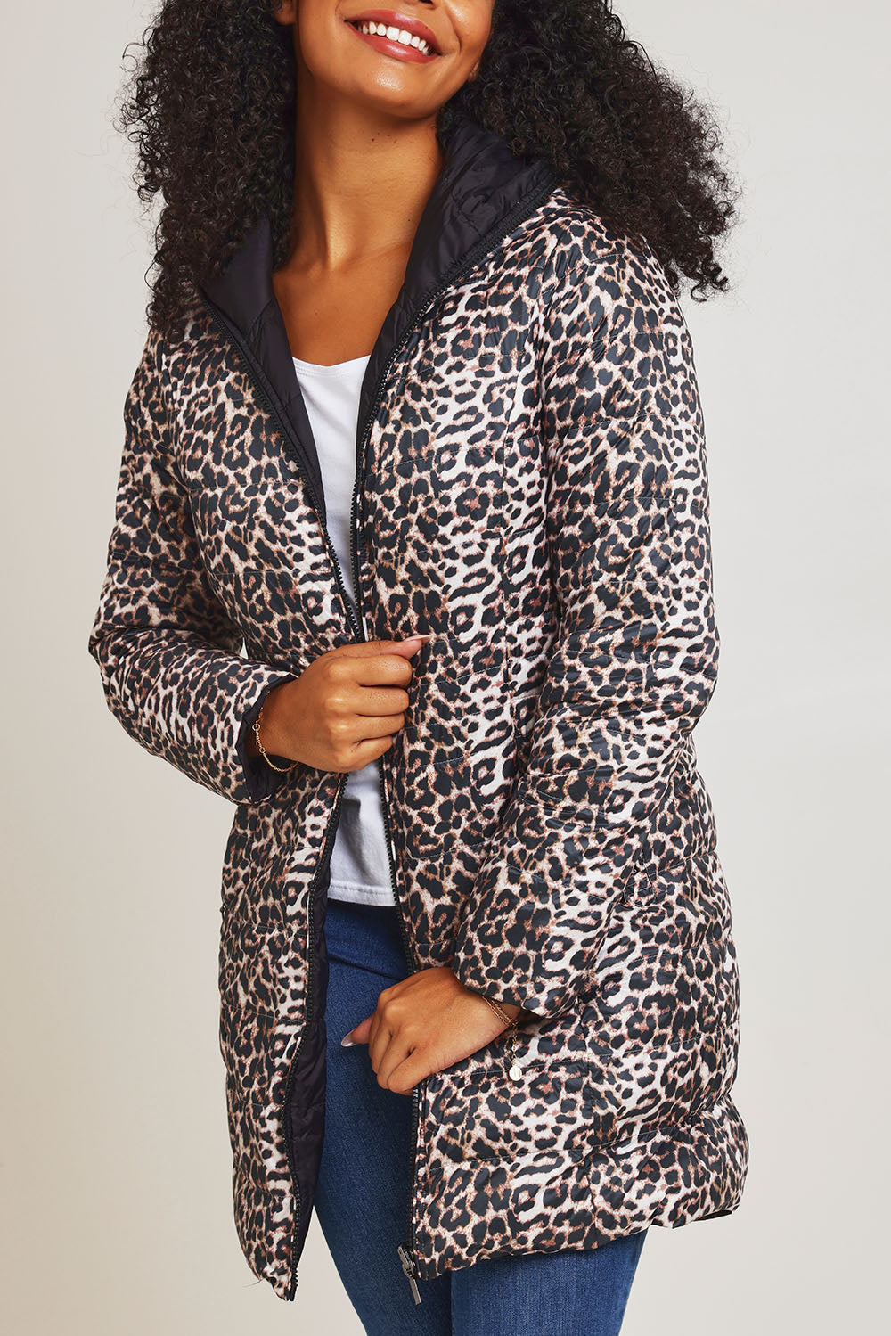 Model Ziara wearing size 10 of the 3/4 Reversible Down Jacket in colour Safari (Black), from the front, cropped image