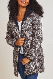 Model Ziara wearing size 10 of the 3/4 Reversible Down Jacket in colour Safari (Black), from the front, cropped image