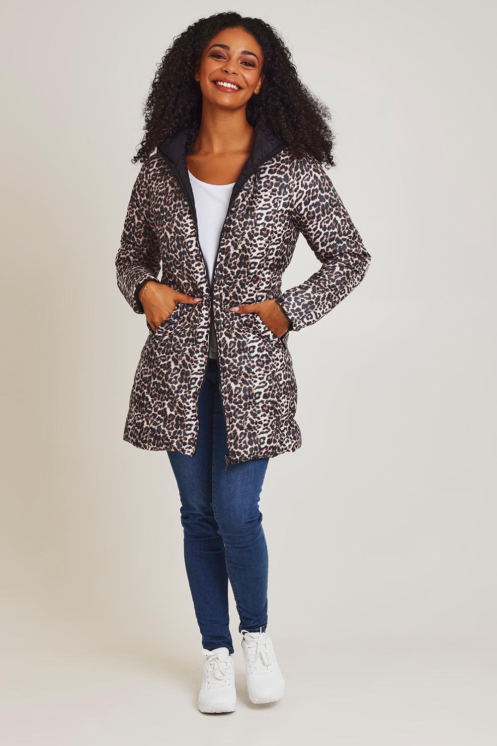 Model Ziara wearing size 10 of the 3/4 Reversible Down Jacket in colour Safari (Black), from the front, showing the whole outfit