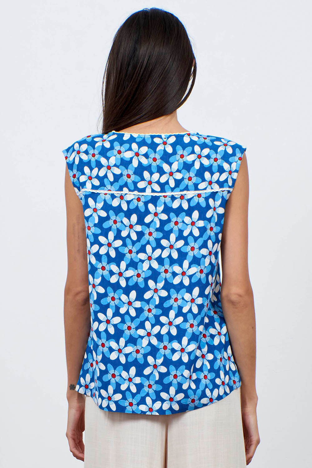 A model wearing the Helen Tank in colour Aster (Blue), from the back