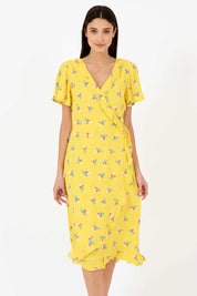 A model wearing the Jenny Dress in colour Bunch, from the front, cropped image