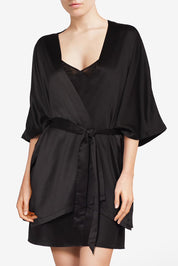 A model wearing Thelma Kimono in colour Black (Black), from the front, cropped image