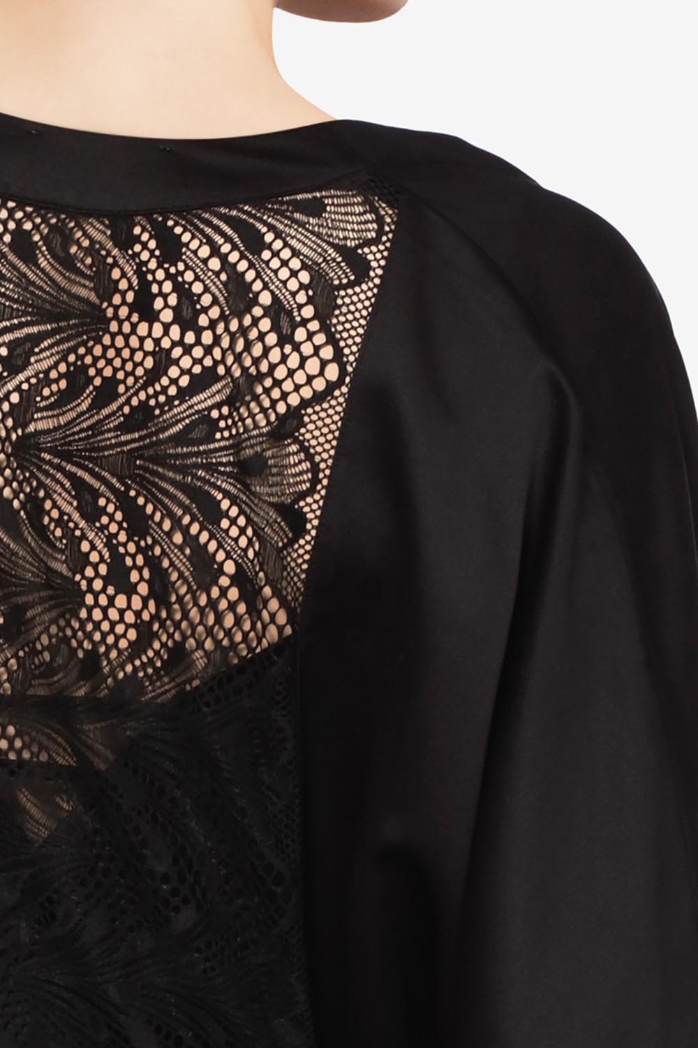 A model wearing Thelma Kimono in colour Black (Black), from the front, cropped image