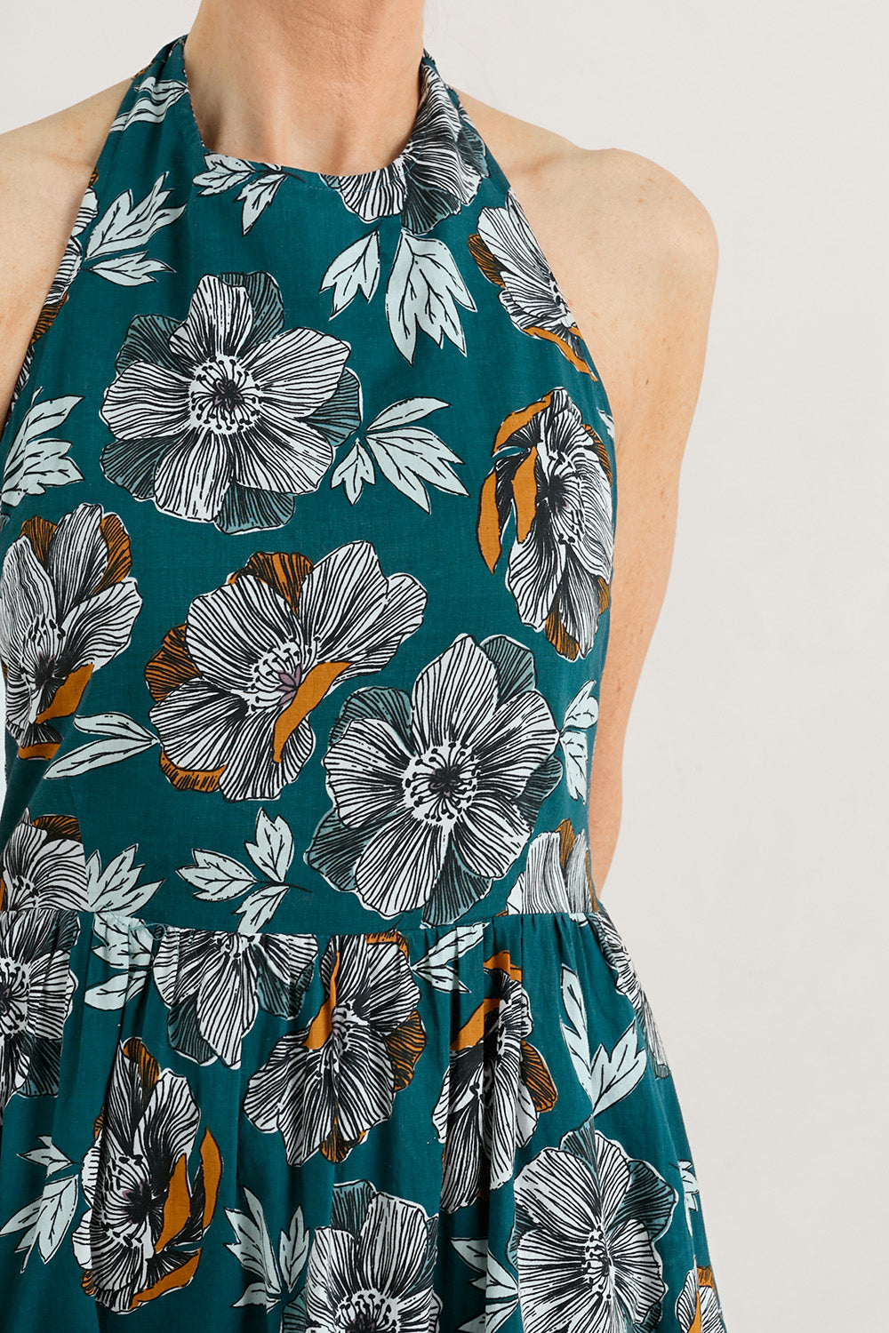 A model wearing the Summer Soul Dress in colour Peony (Green), from the front, cropped image