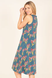 A model wearing the Stemmed Floral Beach Dress in colour Multi (Blue), from the back