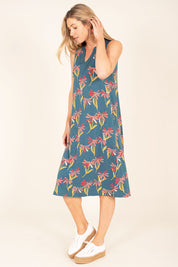 A model wearing the Stemmed Floral Beach Dress in colour Multi (Blue), from the front, showing the whole outfit