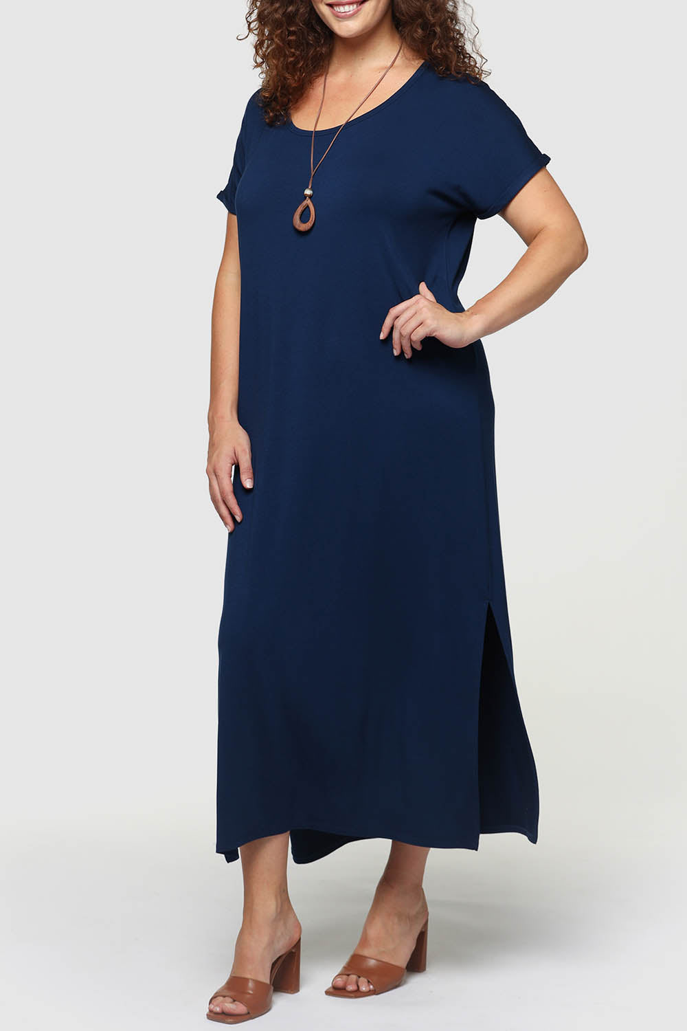 A model wearing the Elsie Dress in colour Navy (Blue), from the front, cropped image