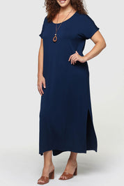 A model wearing the Elsie Dress in colour Navy (Blue), from the front, cropped image