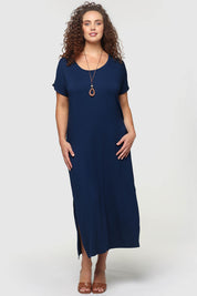 A model wearing the Elsie Dress in colour Navy (Blue), from the front, showing the whole outfit