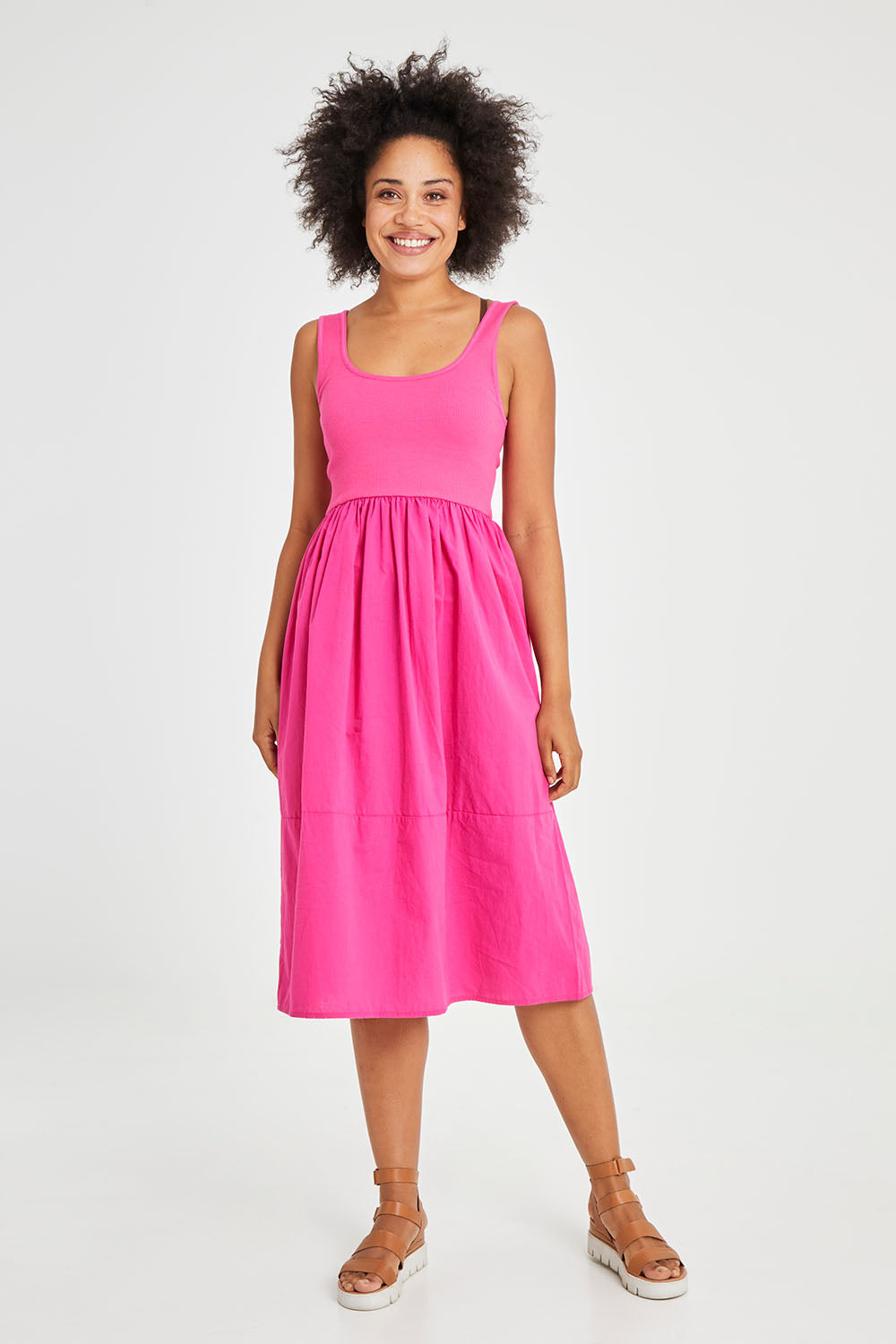 Model Olivia wearing size 10 of the Vienna Sleeveless Dress in colour Pink (Pink), from the front, showing the whole outfit