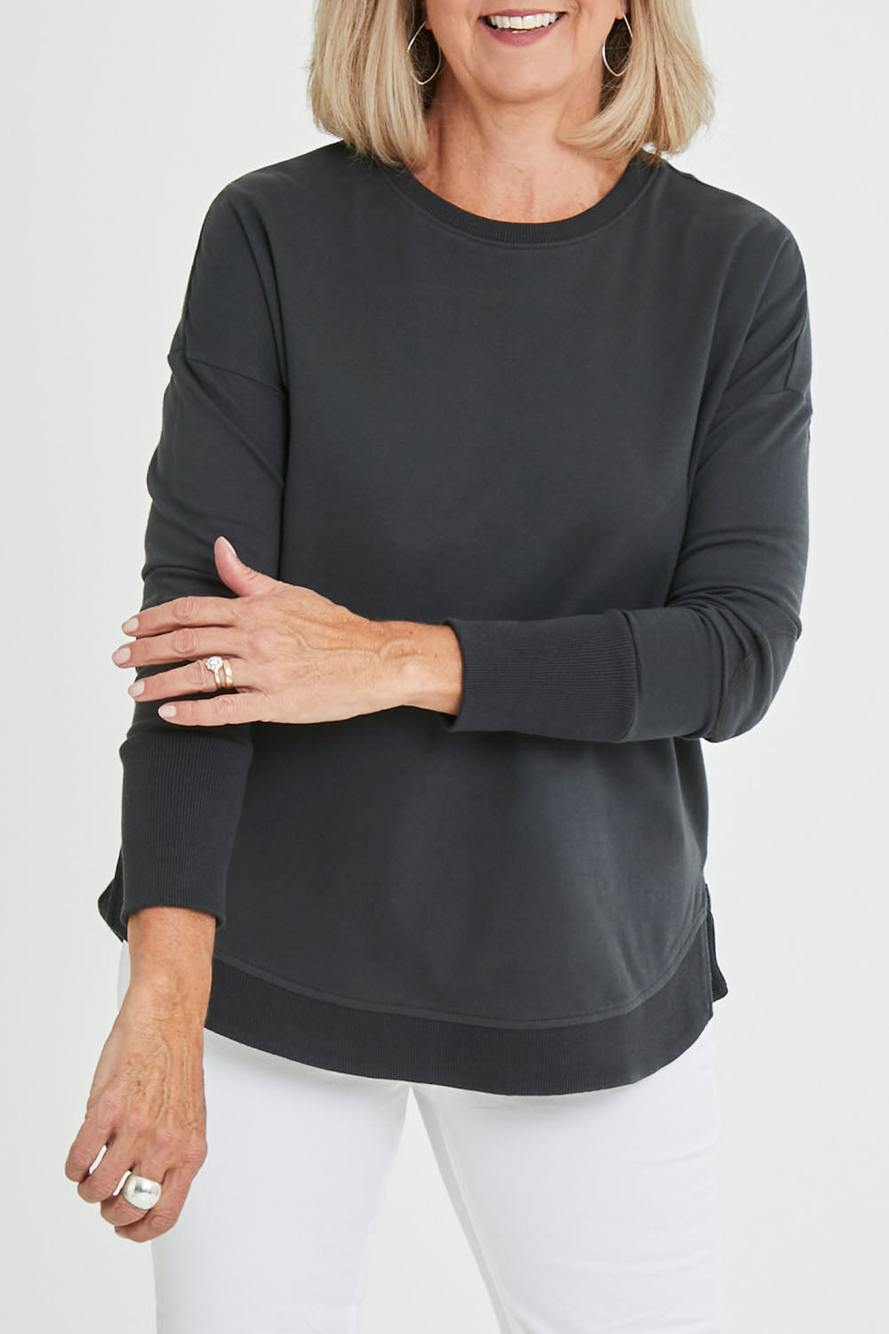 Model Sandy wearing size 10 of the Lucy French Terry Sweat in colour Gunmetal (Grey), from the front, cropped image